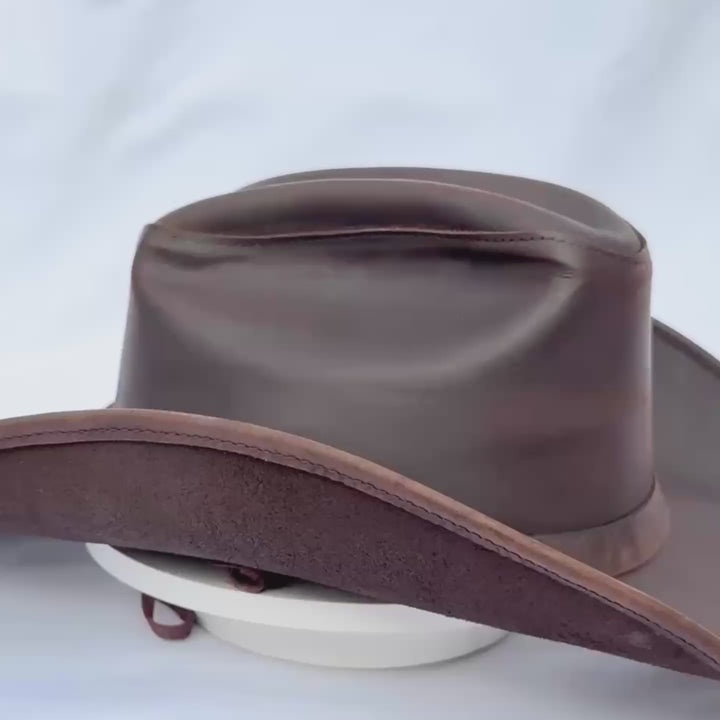 Dark brown leather cowboy hat with a curved brim handmade western rancher